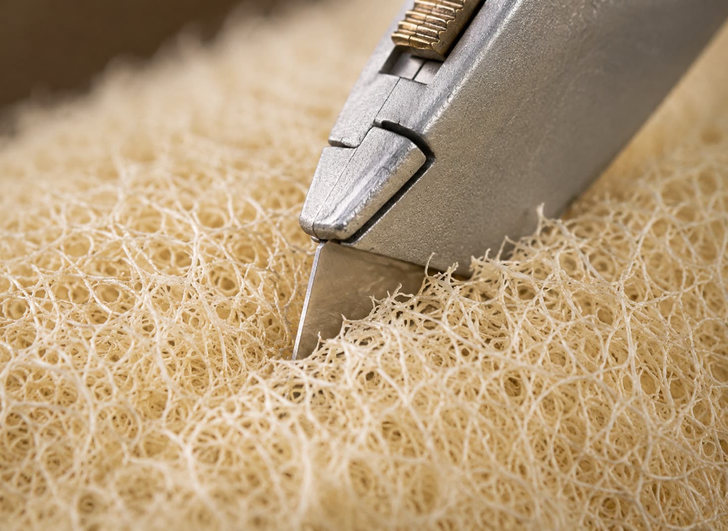 Close-up of a loofah piece being cut to size